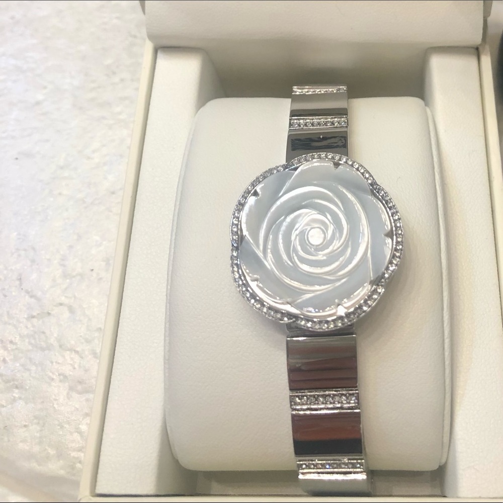 Anne Klein bracelet watch with flower en- casing.